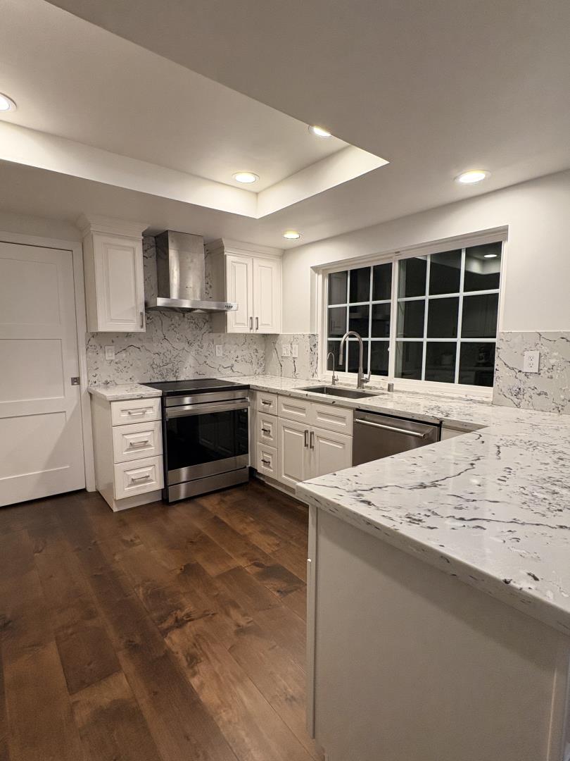 1204 Lubich Drive Mountain View, CA 94040 - Photo 2 of 12 a kitchen with stainless steel appliances granite countertop a sink and a stove top oven