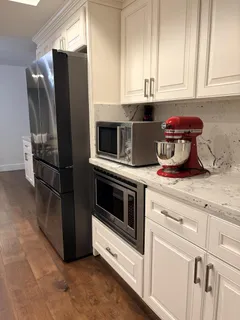 a kitchen with stainless steel appliances granite countertop a refrigerator sink and stove