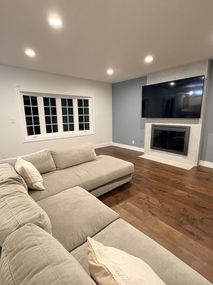 1204 Lubich Drive Mountain View, CA 94040 - Photo 8 of 12 a living room with furniture and a flat screen tv