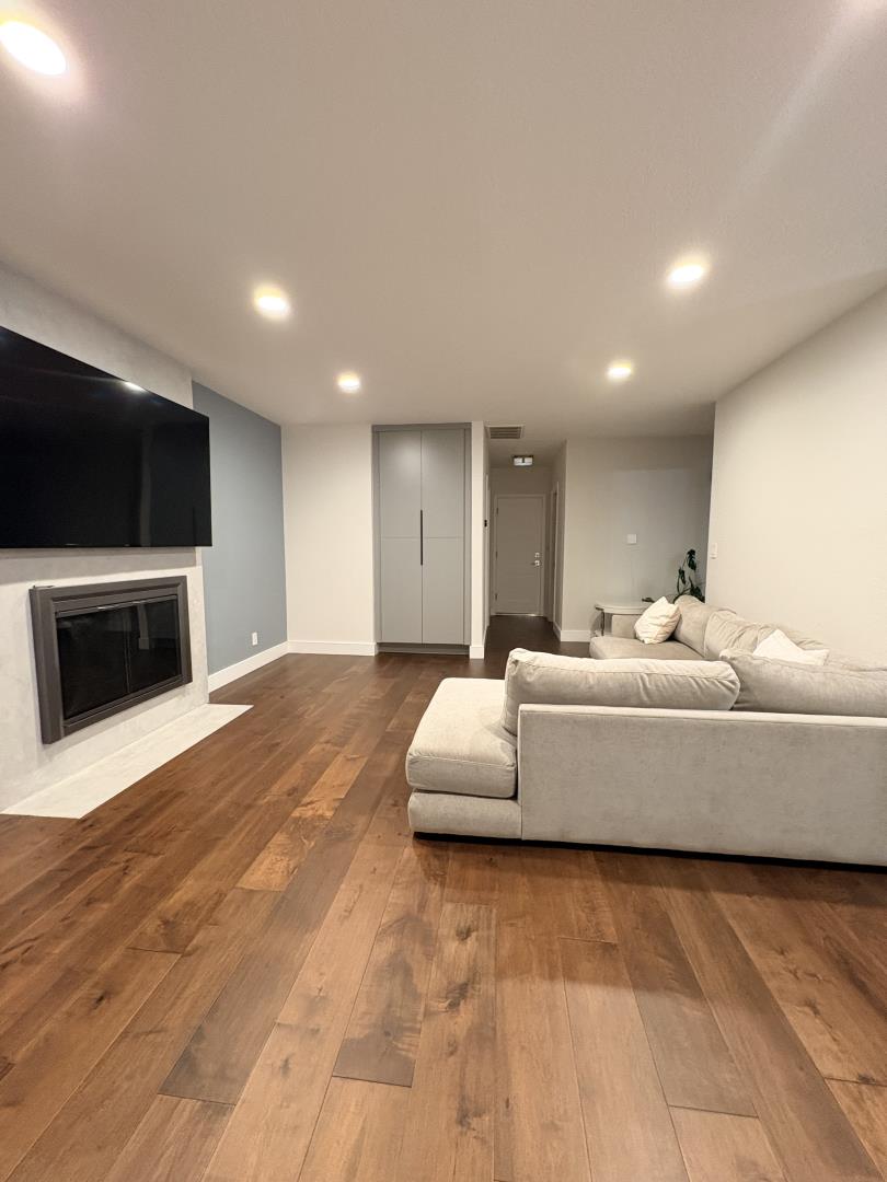1204 Lubich Drive Mountain View, CA 94040 - Photo 9 of 12 a living room with furniture a flat screen tv and a fireplace