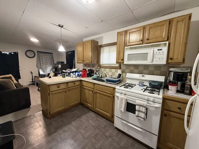 a kitchen with a stove sink and a microwave