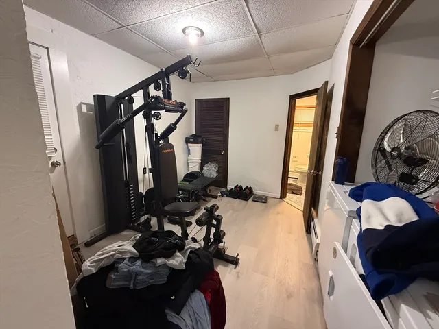 a bedroom with bed and a mirror