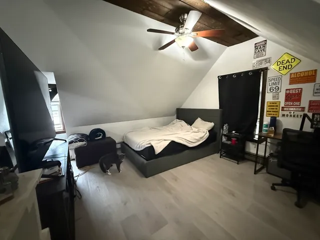 a bed room with a bed furniture and a flat screen tv