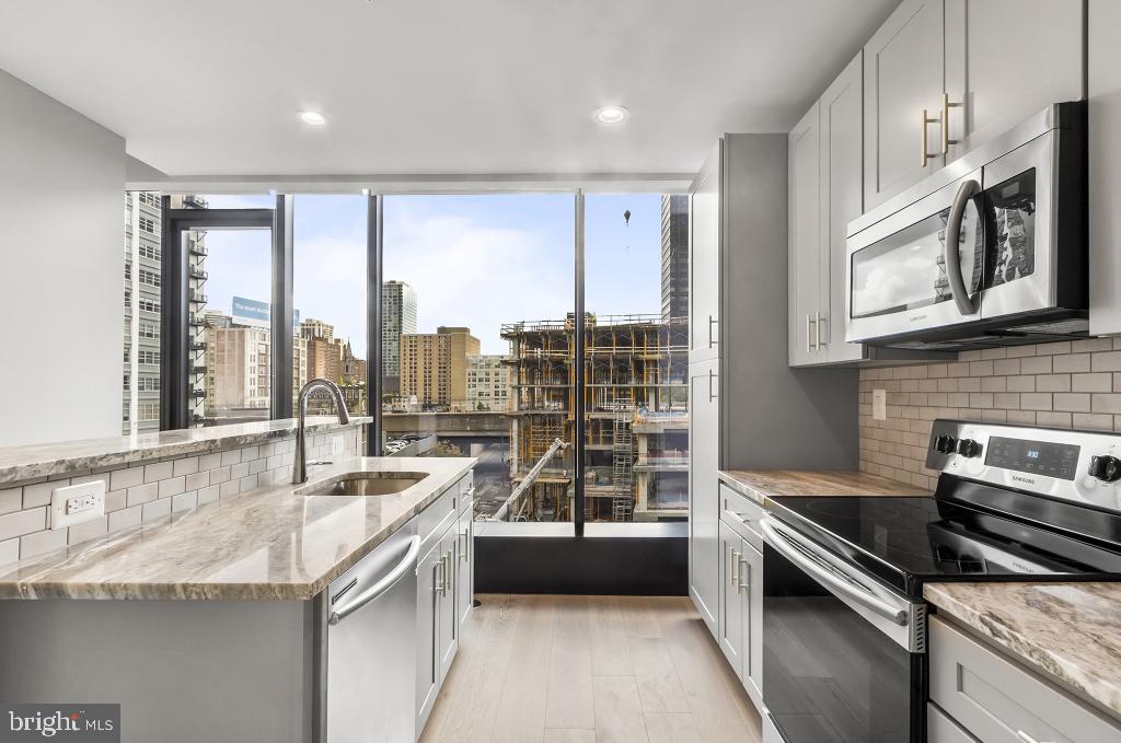 30 North 23rd Street Philadelphia, PA 19103 - Photo 8 of 26 a kitchen with stainless steel appliances granite countertop a stove and a sink