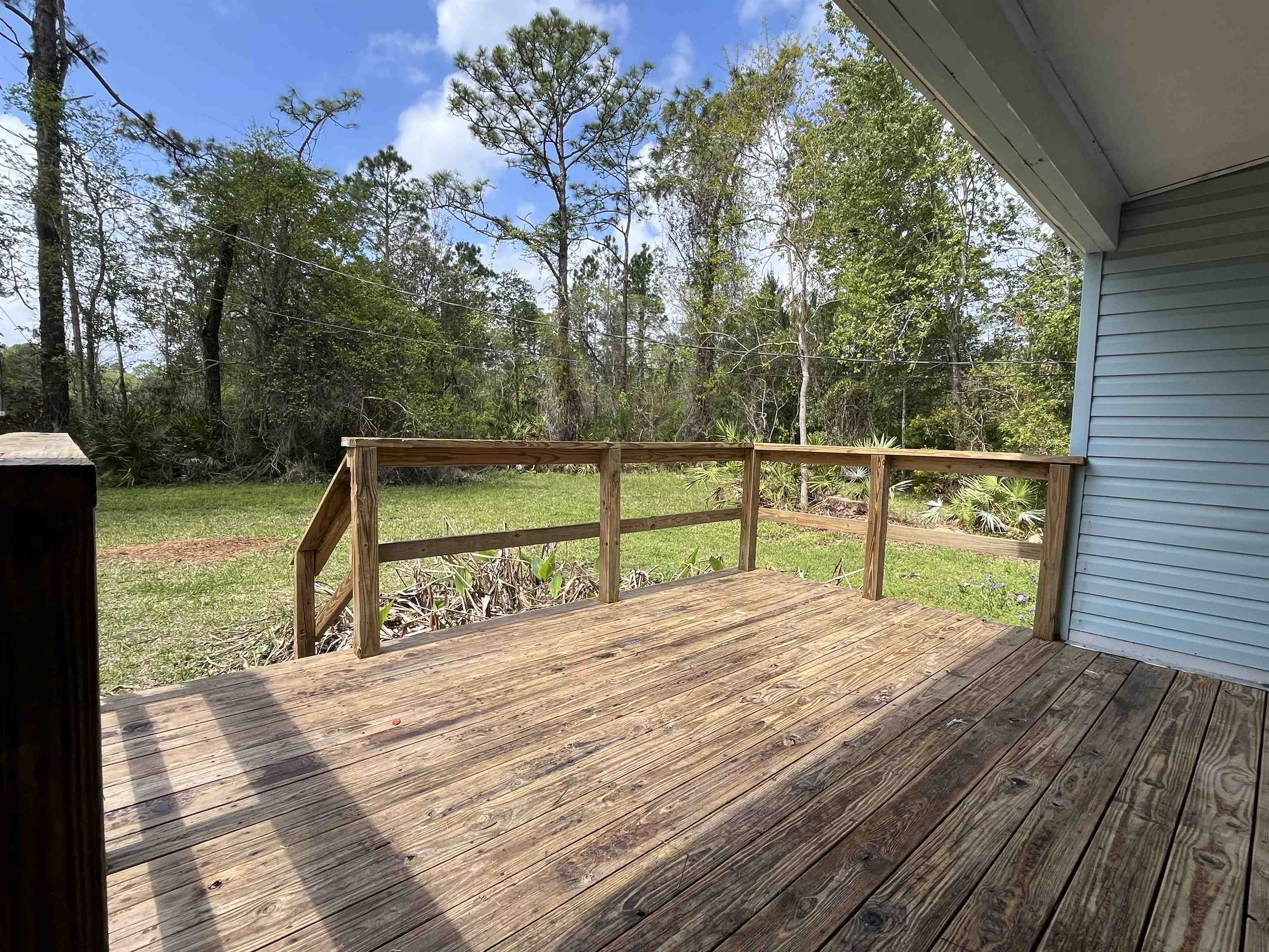 1340 Thompson Bailey Road St. Augustine, FL 32084 - Photo 18 of 21 a view of a deck with a yard