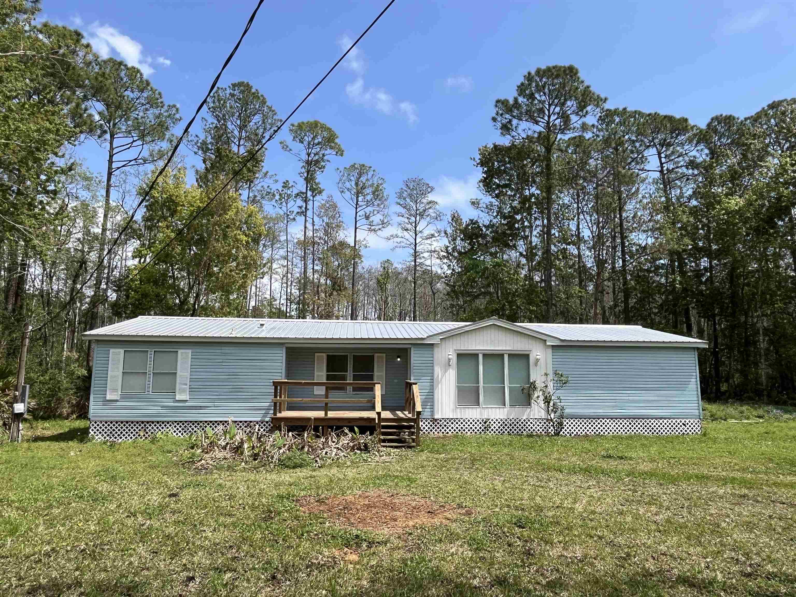 1340 Thompson Bailey Road St. Augustine, FL 32084 - Photo 2 of 21 a backyard of a house with table and chairs