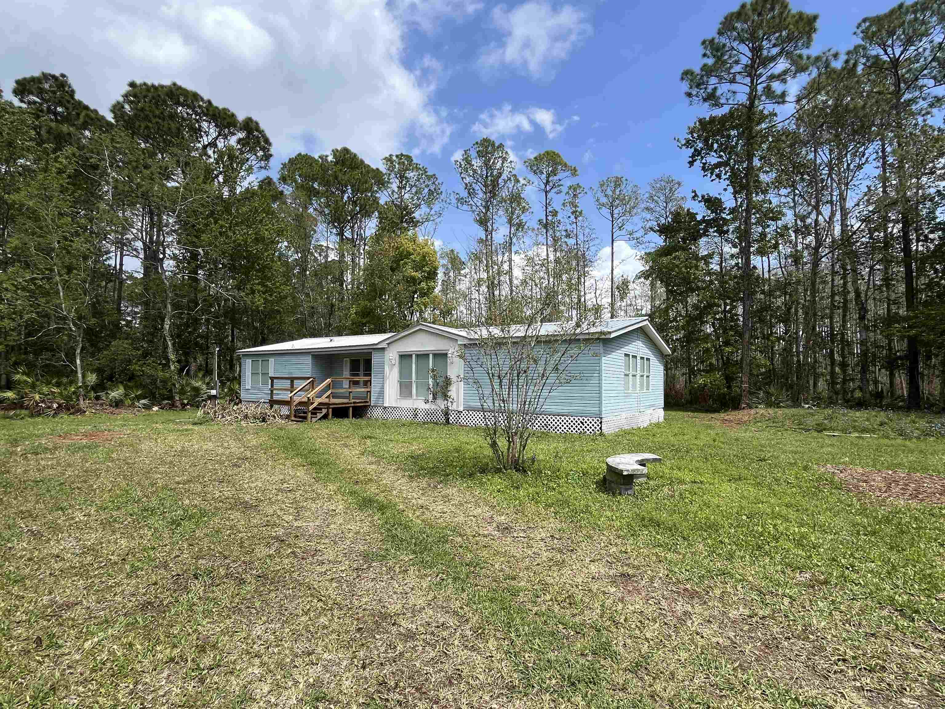 1340 Thompson Bailey Road St. Augustine, FL 32084 - Photo 21 of 21 a view of a big yard in front of a house with large trees