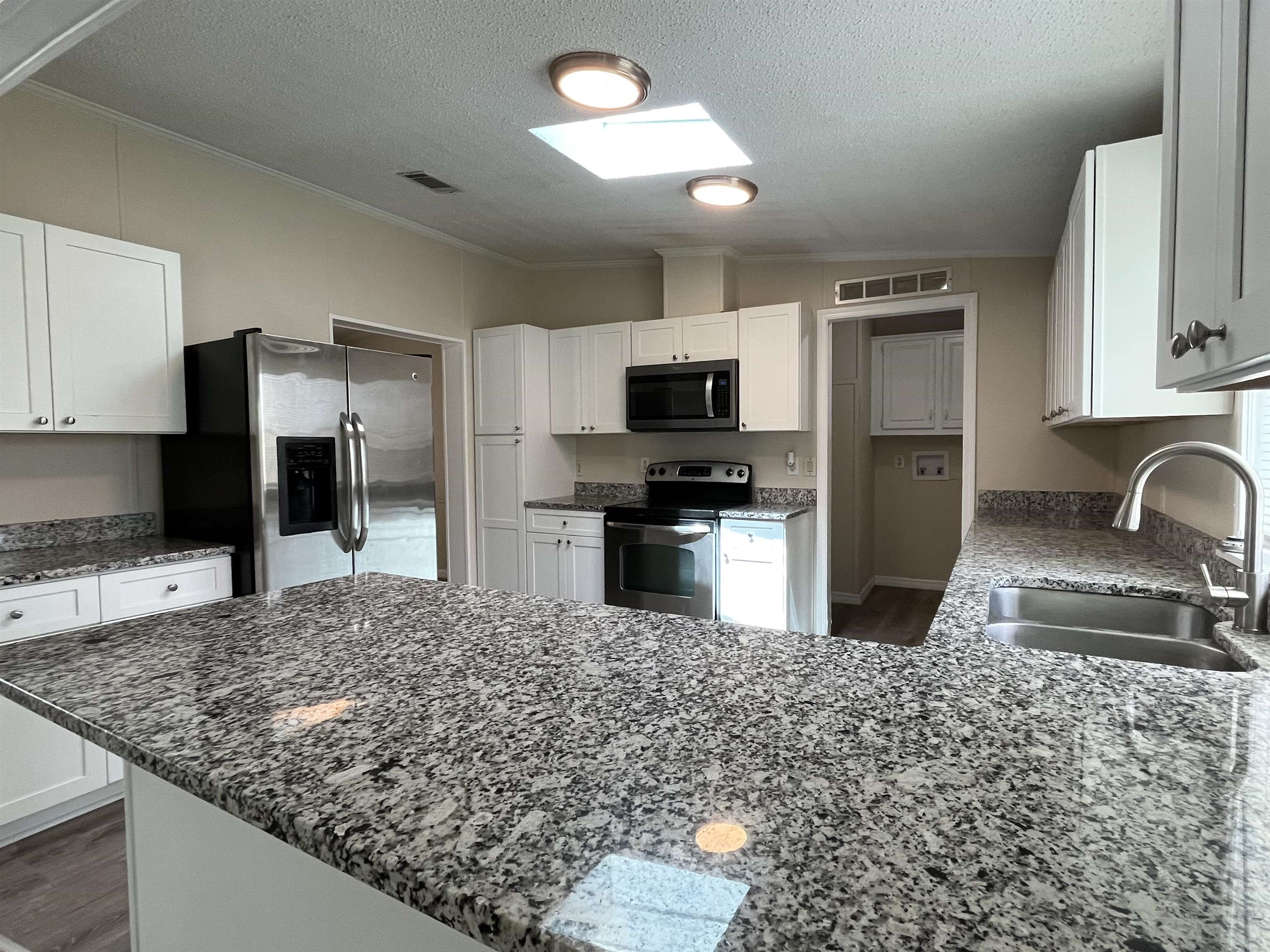 1340 Thompson Bailey Road St. Augustine, FL 32084 - Photo 7 of 21 a kitchen with stainless steel appliances granite countertop a sink stove and refrigerator