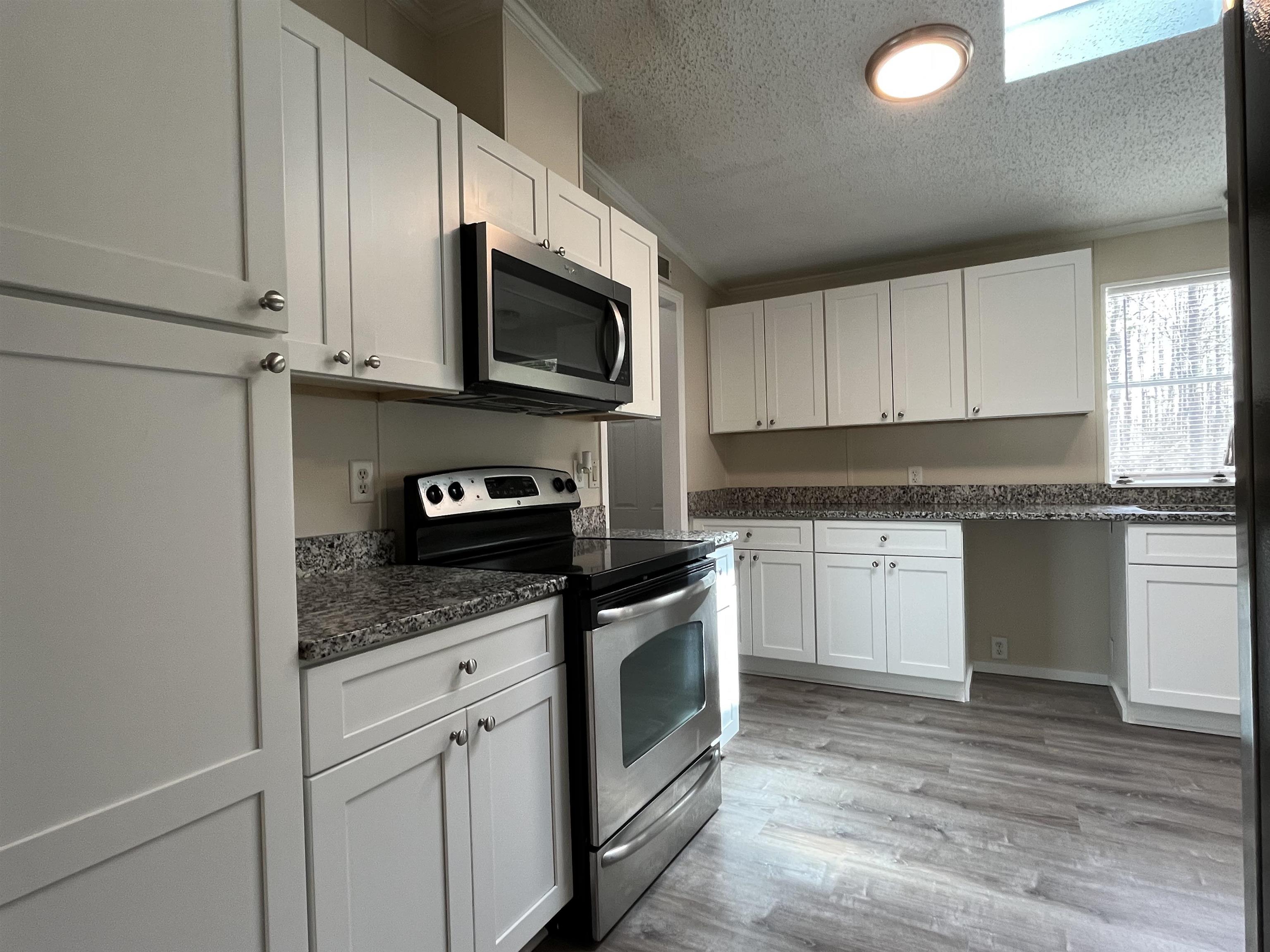 1340 Thompson Bailey Road St. Augustine, FL 32084 - Photo 10 of 21 a kitchen with granite countertop white cabinets stainless steel appliances and a sink