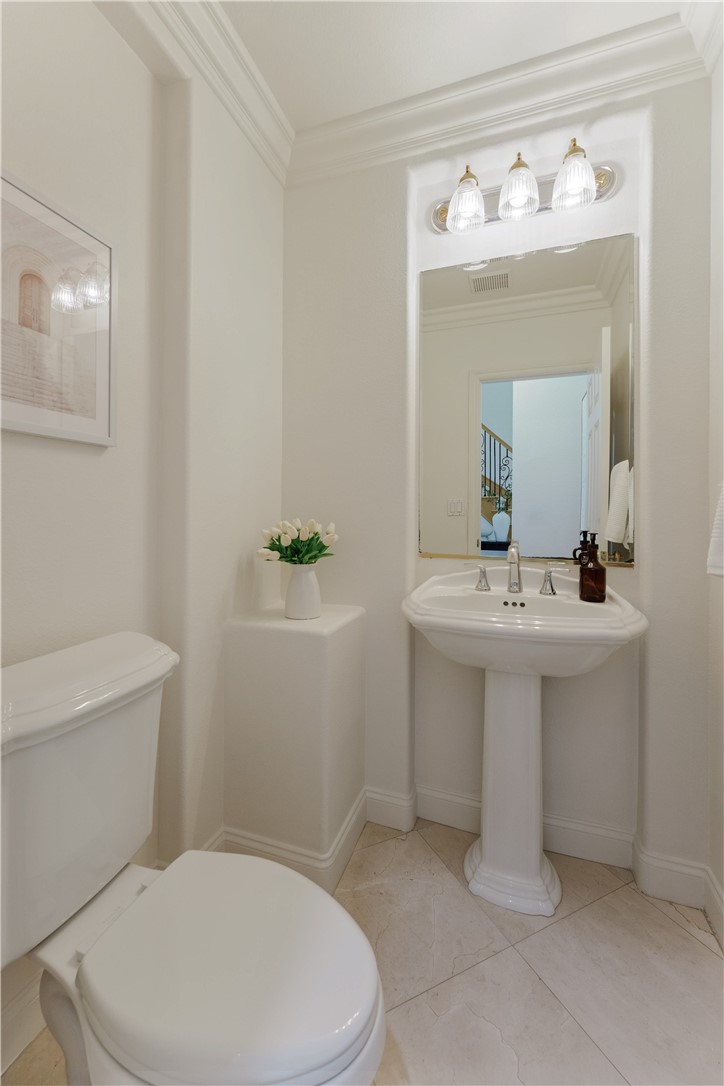 5464 Shannon Ridge Lane San Diego, CA 92130 - Photo 19 of 44 a bathroom with a sink a mirror and a toilet