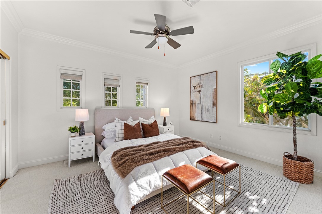5464 Shannon Ridge Lane San Diego, CA 92130 - Photo 20 of 44 a bedroom with a bed lamp and a potted plant