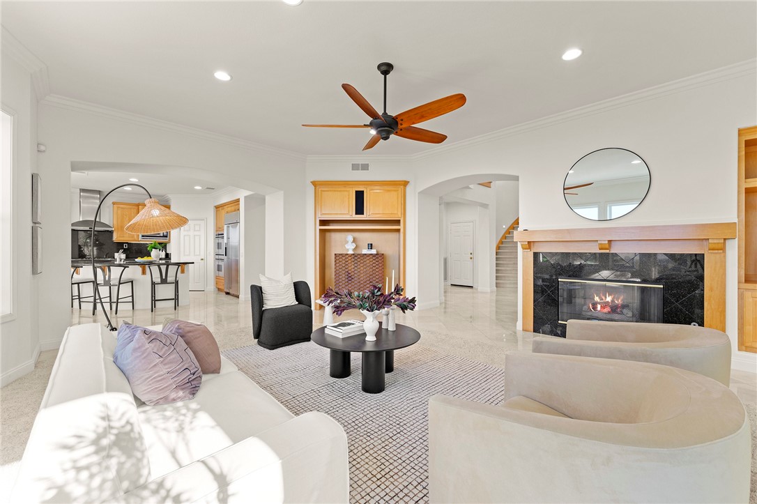 5464 Shannon Ridge Lane San Diego, CA 92130 - Photo 9 of 44 a living room with furniture a fireplace and a chandelier