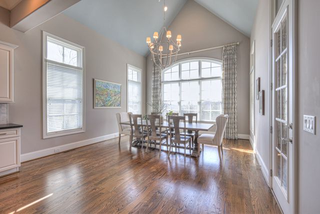 a bathroom with a granite countertop toilet a sink and a mirror