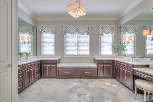 a bathroom with a double vanity sink a toilet and a mirror