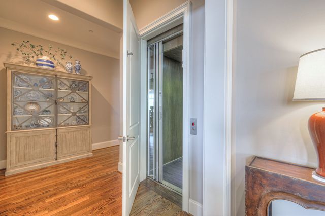 a kitchen with stainless steel appliances granite countertop a dining table chairs refrigerator and sink