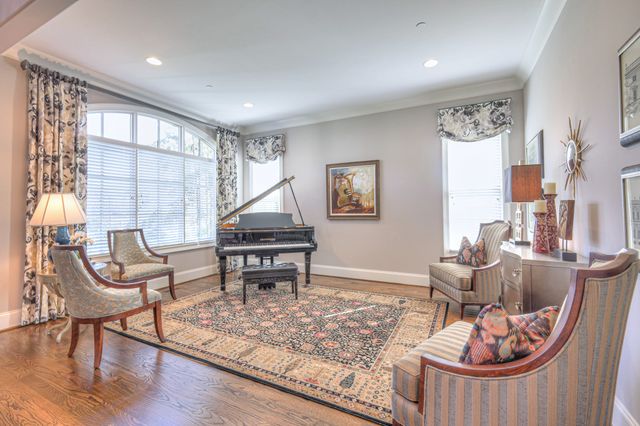 a living room with furniture a fireplace and a large window