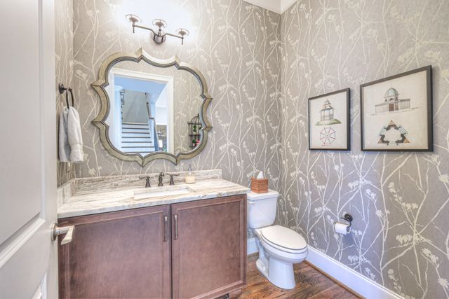 a living room with furniture a flat screen tv and wooden floor