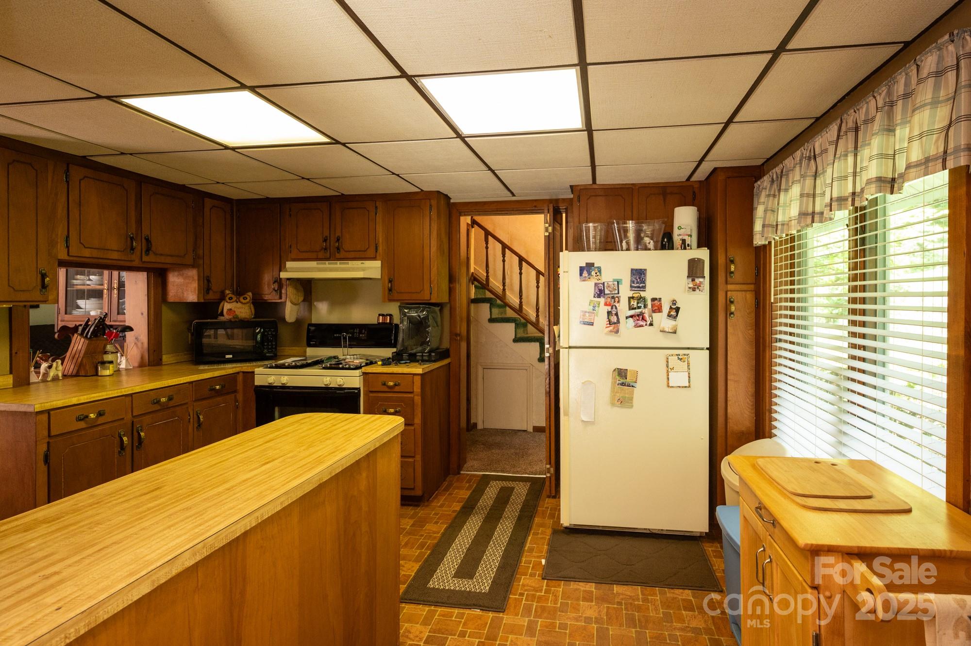 230 West Cove Lane Boone, NC 28607 - Photo 11 of 46 a kitchen with stainless steel appliances granite countertop a sink a stove a refrigerator cabinets and wooden floor