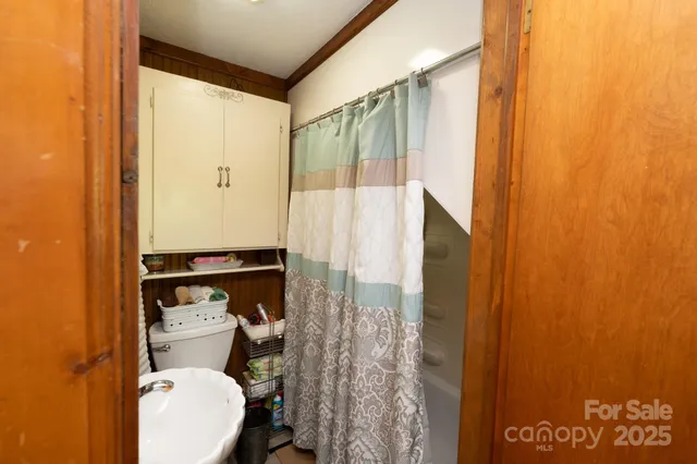 a bedroom with furniture and large windows