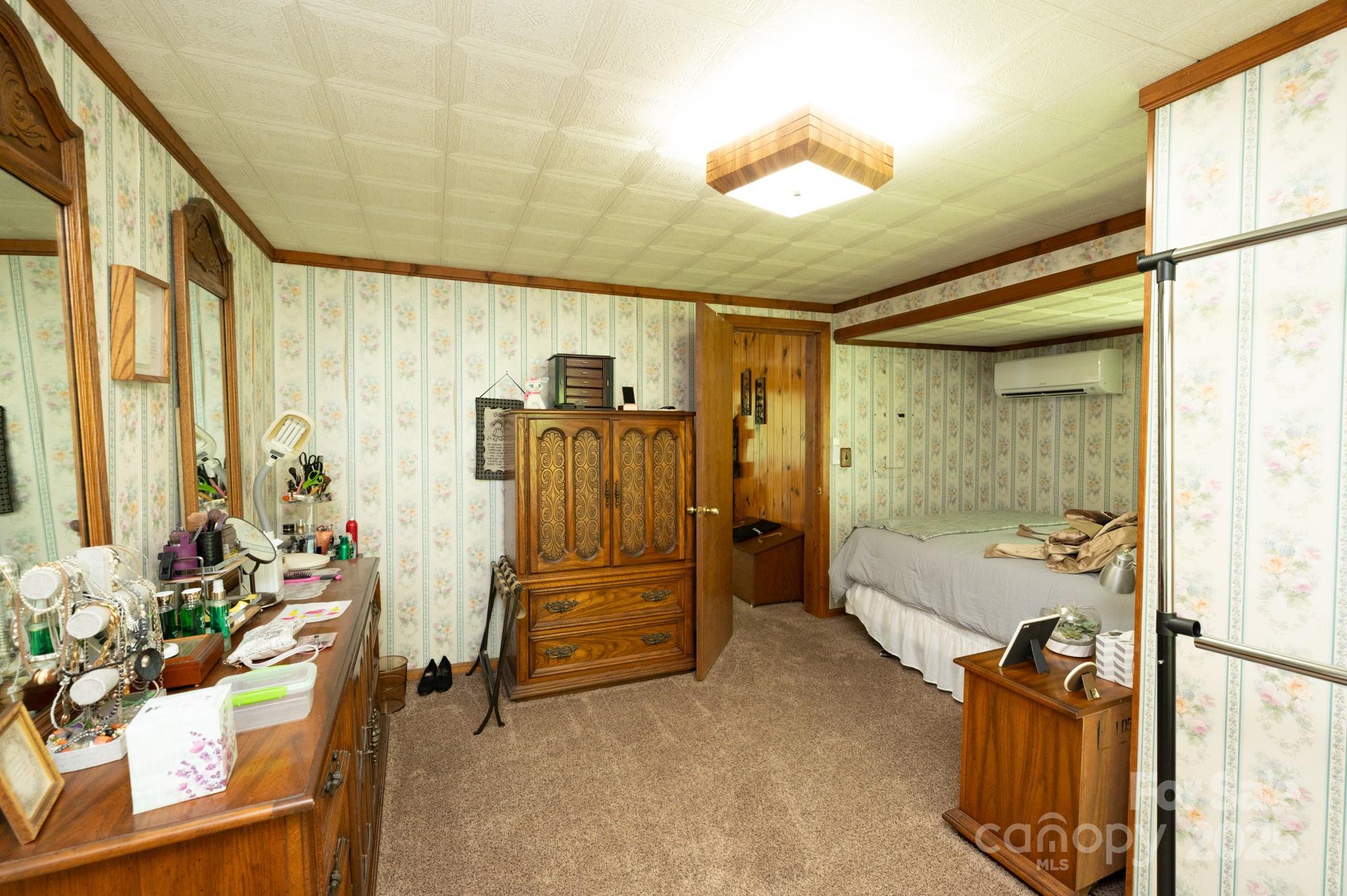 230 West Cove Lane Boone, NC 28607 - Photo 13 of 46 a bedroom with furniture and large windows