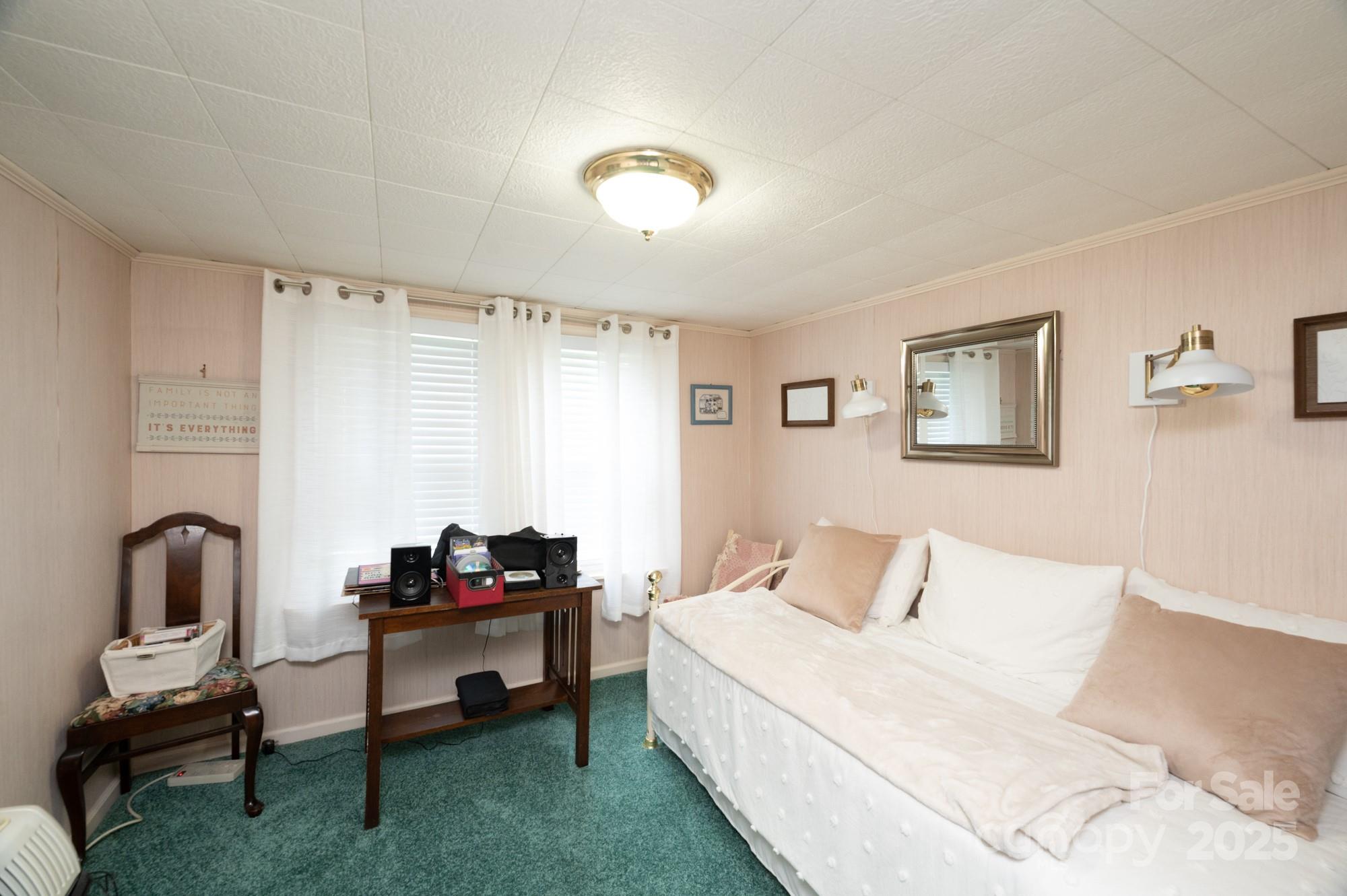 230 West Cove Lane Boone, NC 28607 - Photo 18 of 46 a bedroom with a bed and a chair