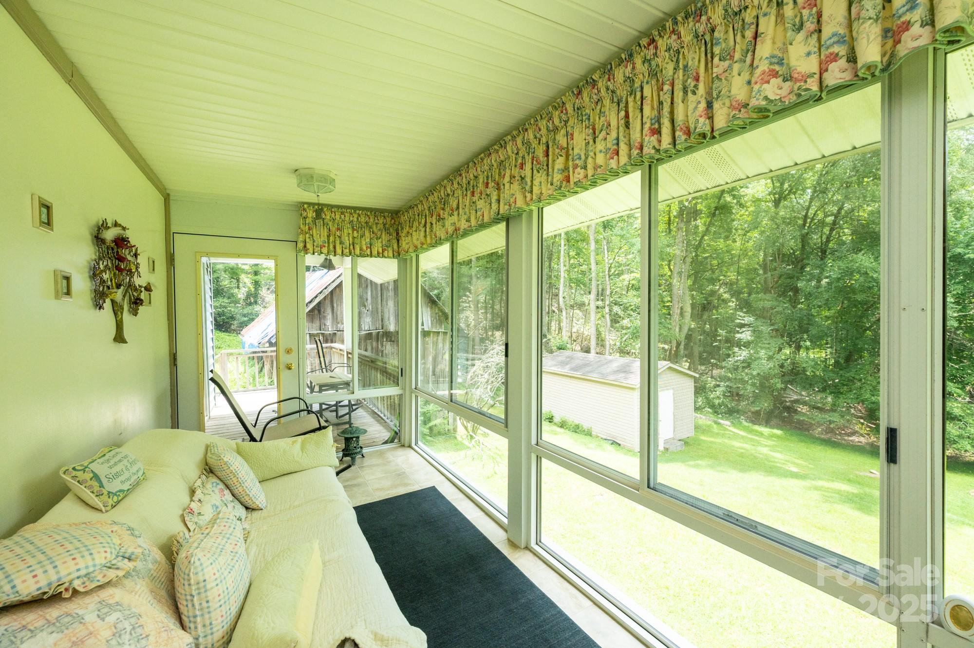 230 West Cove Lane Boone, NC 28607 - Photo 20 of 46 a bed sitting in a bedroom next to a window