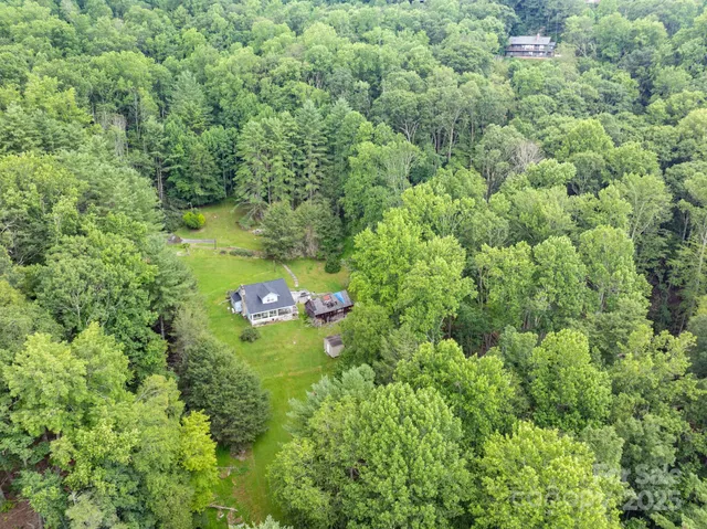 an aerial view of a house with pool outdoor space and garden