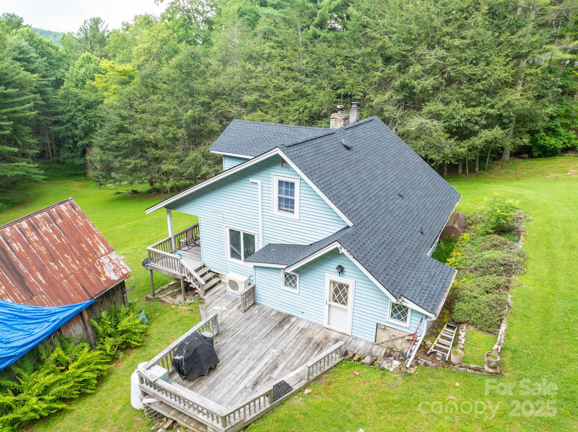 230 West Cove Lane Boone, NC 28607 - Photo 6 of 46 a aerial view of a house with swimming pool next to a big yard