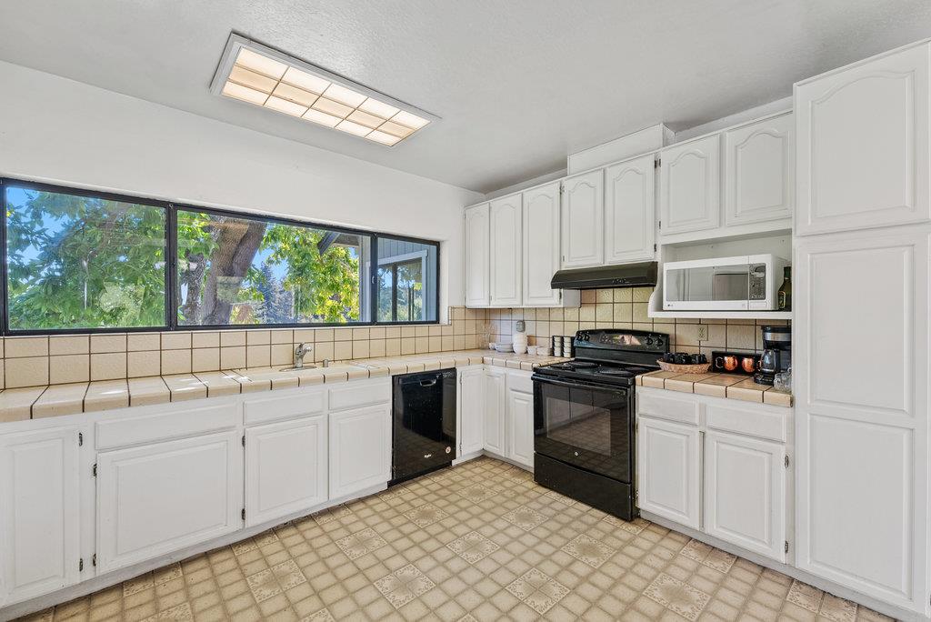 500 Valencia School Road Aptos, CA 95003 - Photo 16 of 44 a kitchen with a sink stove and cabinets