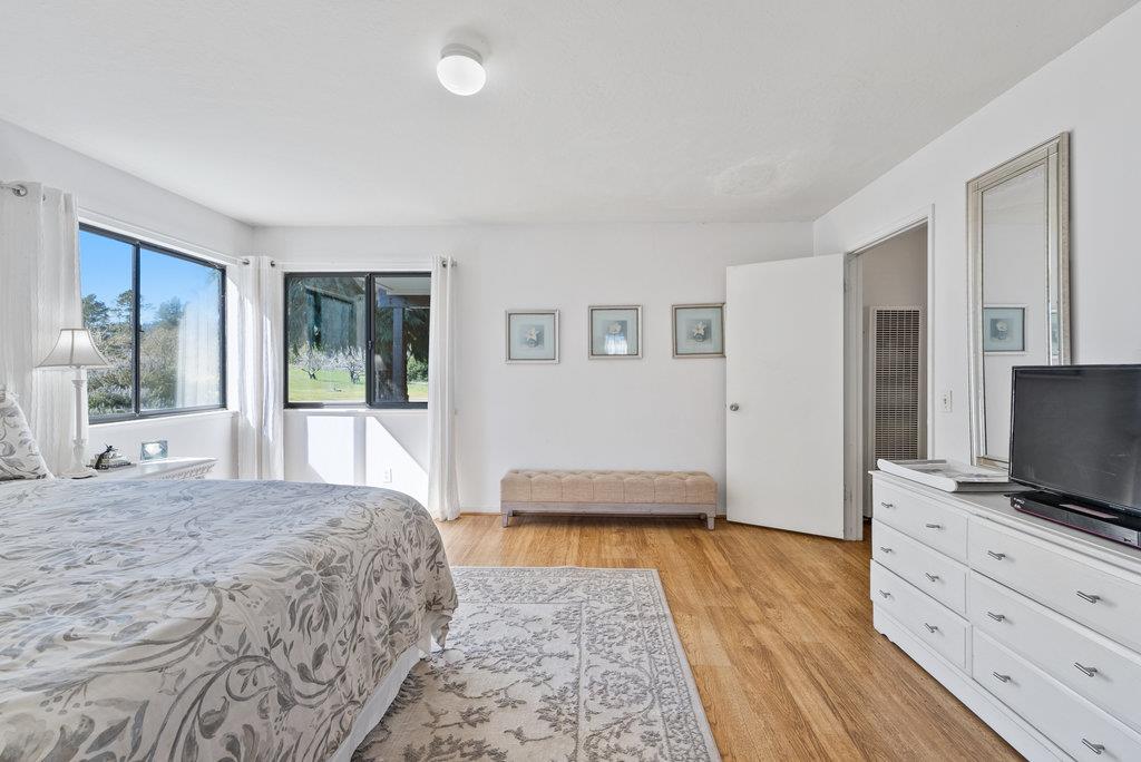 500 Valencia School Road Aptos, CA 95003 - Photo 19 of 44 a bedroom with a bed and a flat screen tv