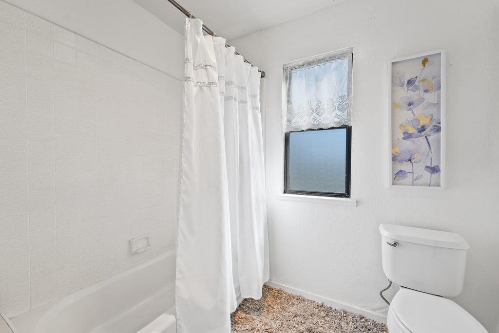 500 Valencia School Road Aptos, CA 95003 - Photo 22 of 44 a bathroom with a toilet and a shower curtain