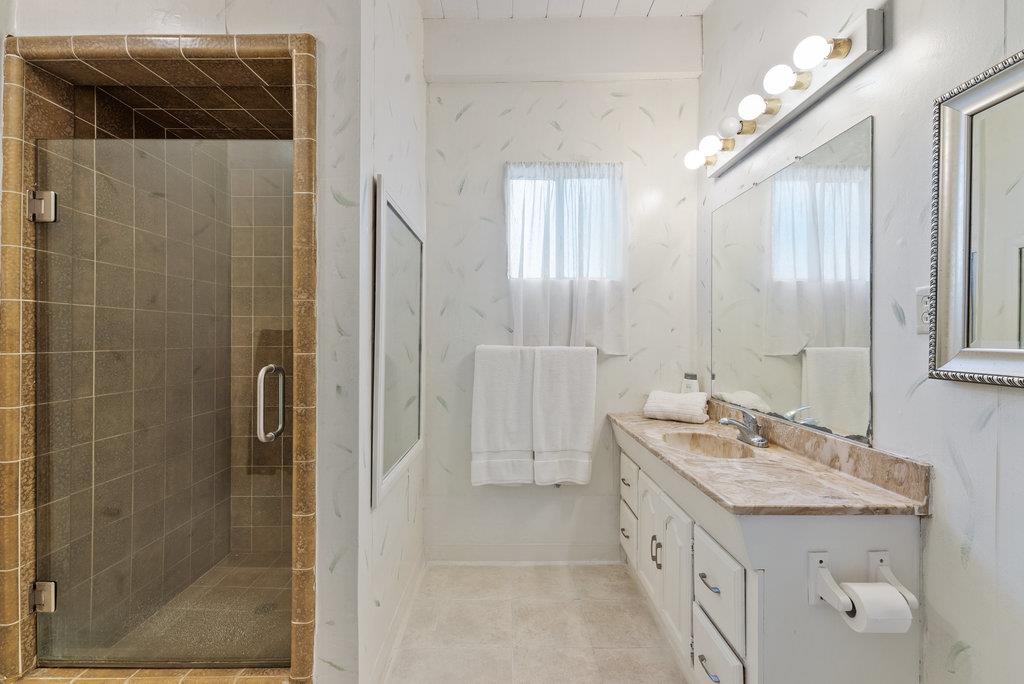 500 Valencia School Road Aptos, CA 95003 - Photo 24 of 44 a bathroom with a double vanity sink a large mirror and shower
