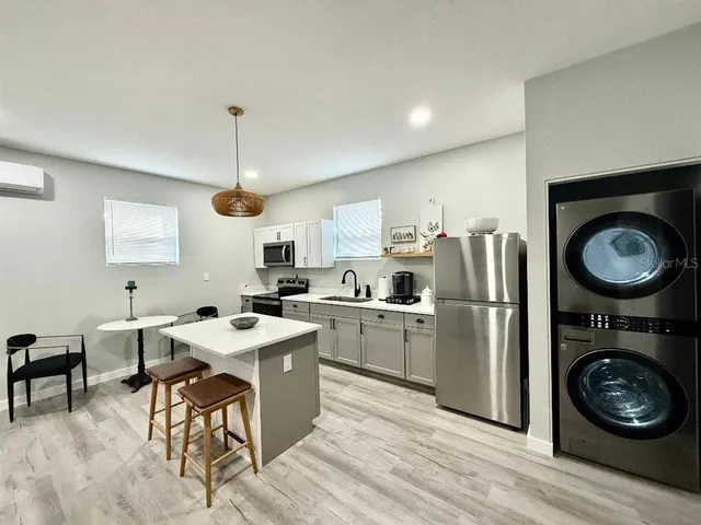 a kitchen with a stove a refrigerator and a fireplace