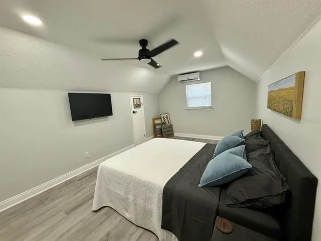 a large bed sitting in a bedroom next to a lamp