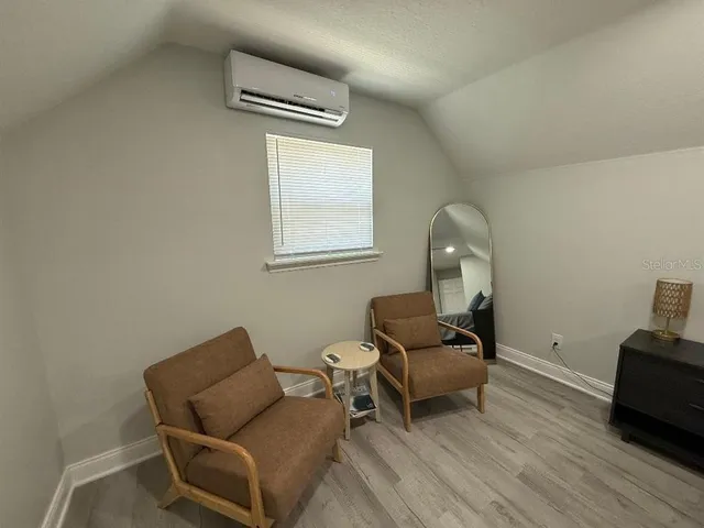 a large bed sitting in a bedroom next to a window