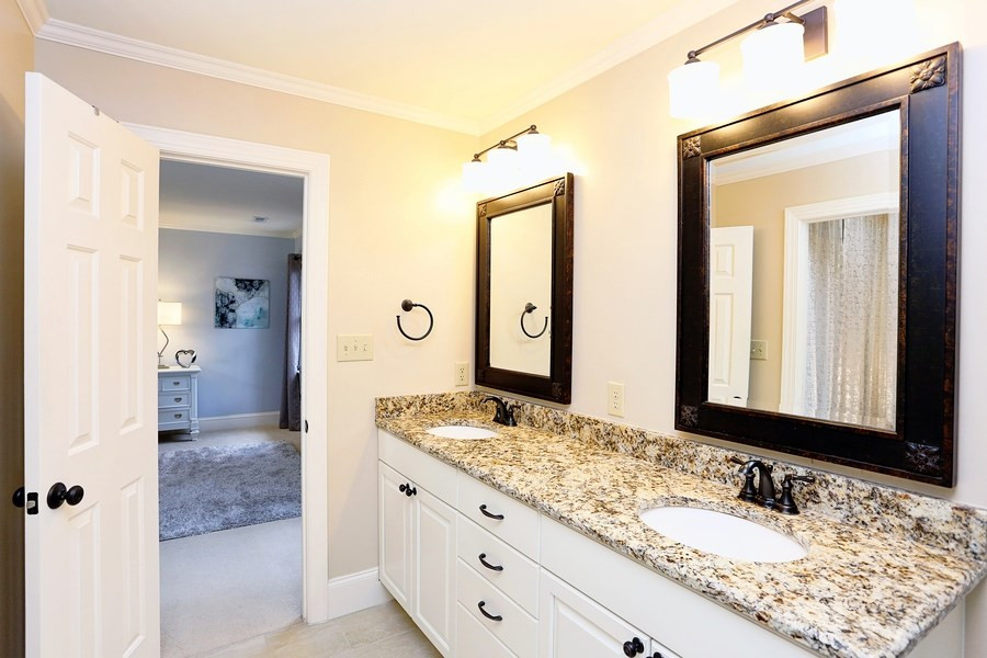 621 Hawick Road Raleigh, NC 27615 - Photo 16 of 25 Updated bath with granite counter-tops, double vanity, new cabinetry, tiled floor and shower. Master Bath