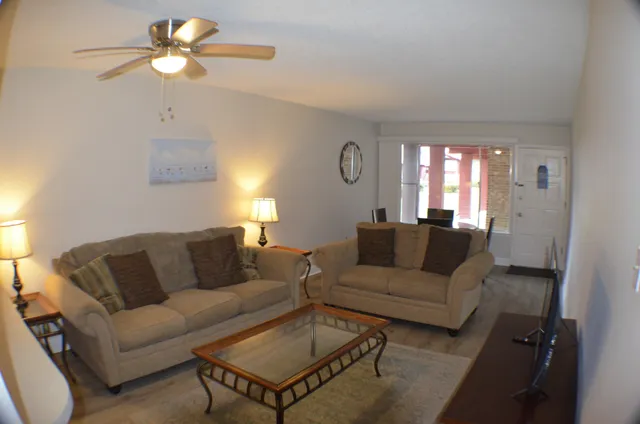 a living room with furniture a couch and a chandelier