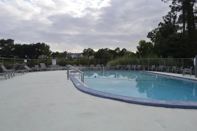 a view of swimming pool with lake and mountain in the back