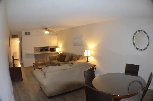 a living room with furniture and a mirror