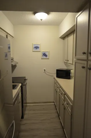 a kitchen with a sink and a refrigerator