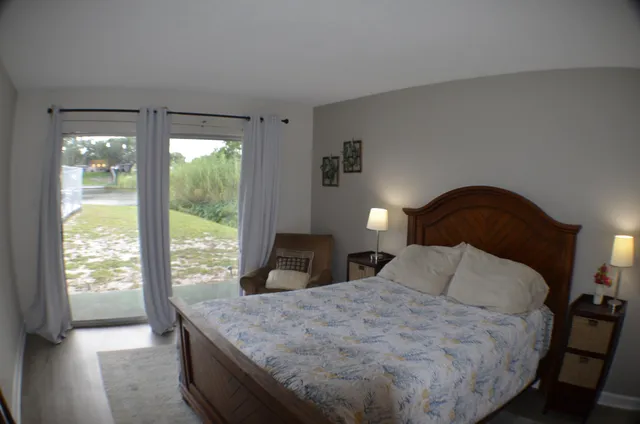 a bedroom with a bed and glass door