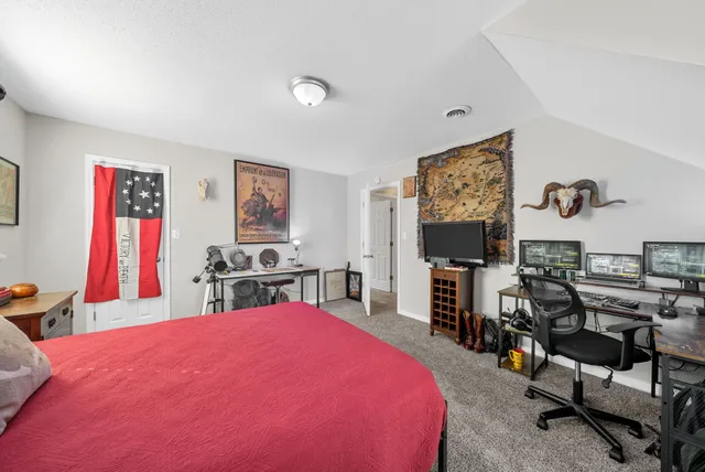 a bathroom with a granite countertop double vanity sink and mirror