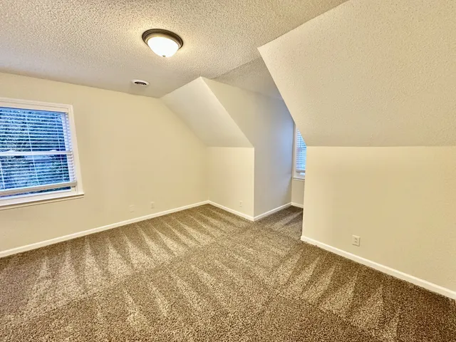 a balcony with wooden floor table and chairs