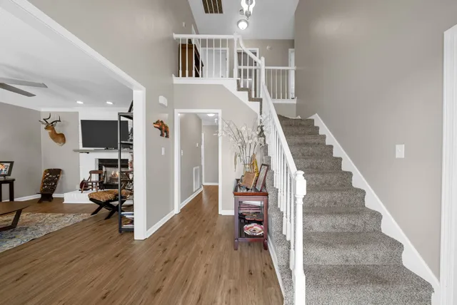 a living room with furniture a rug and a flat screen tv