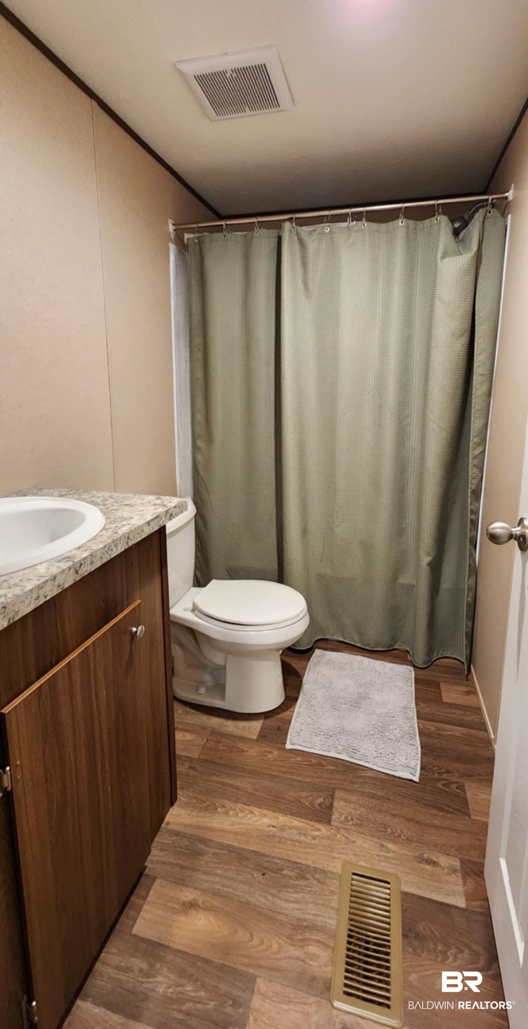 25474 Waterworld Road Robertsdale, AL 36567 - Photo 26 of 30 Full bathroom with vanity, dark wood-style floors, and curtained shower