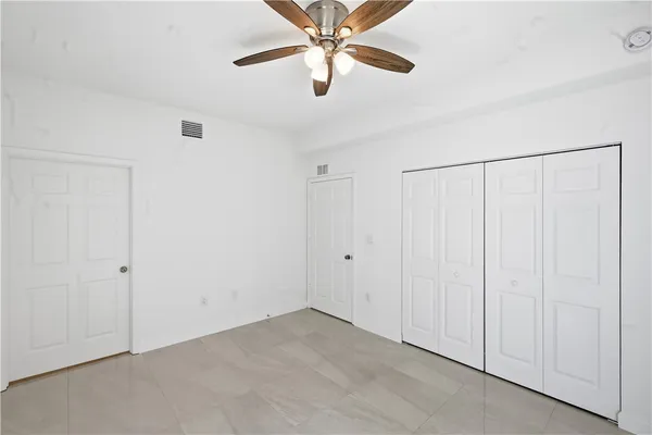 a view of a room with a ceiling fan