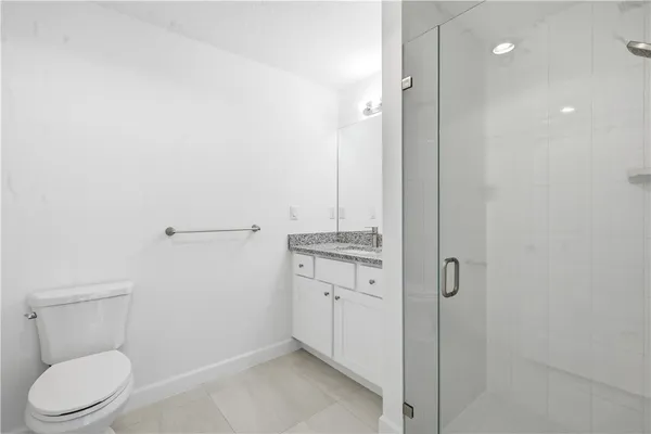 a bathroom with a toilet a sink and a mirror