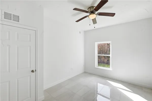 a view of a livingroom with a ceiling fan and window