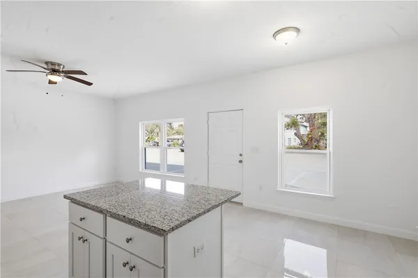 a kitchen with cabinets appliances and a window