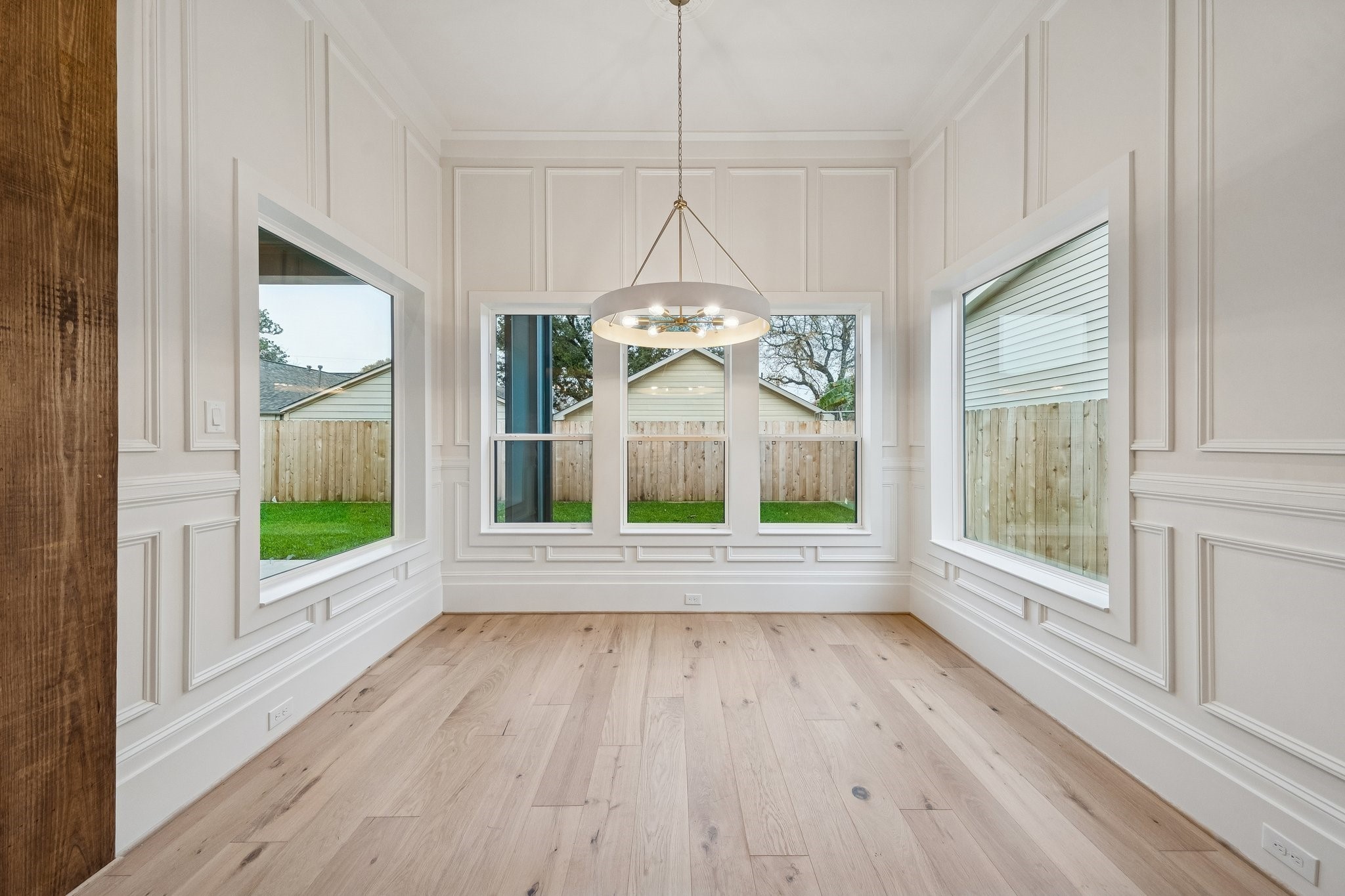 511 Graceland Street Houston, TX 77009 - Photo 4 of 10 Dining room with trim paneled walls and framed windows.